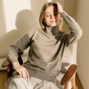 studio-portrait-of-a-young-woman-in-sweater-on-beige-background-.jpg